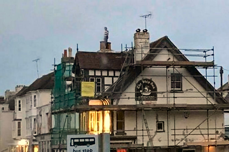man on roof of Ship Inn 2019